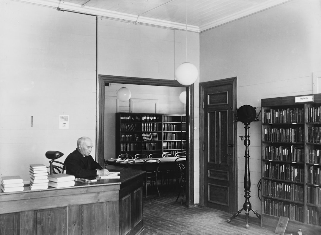 a man sitting at a desk in a library