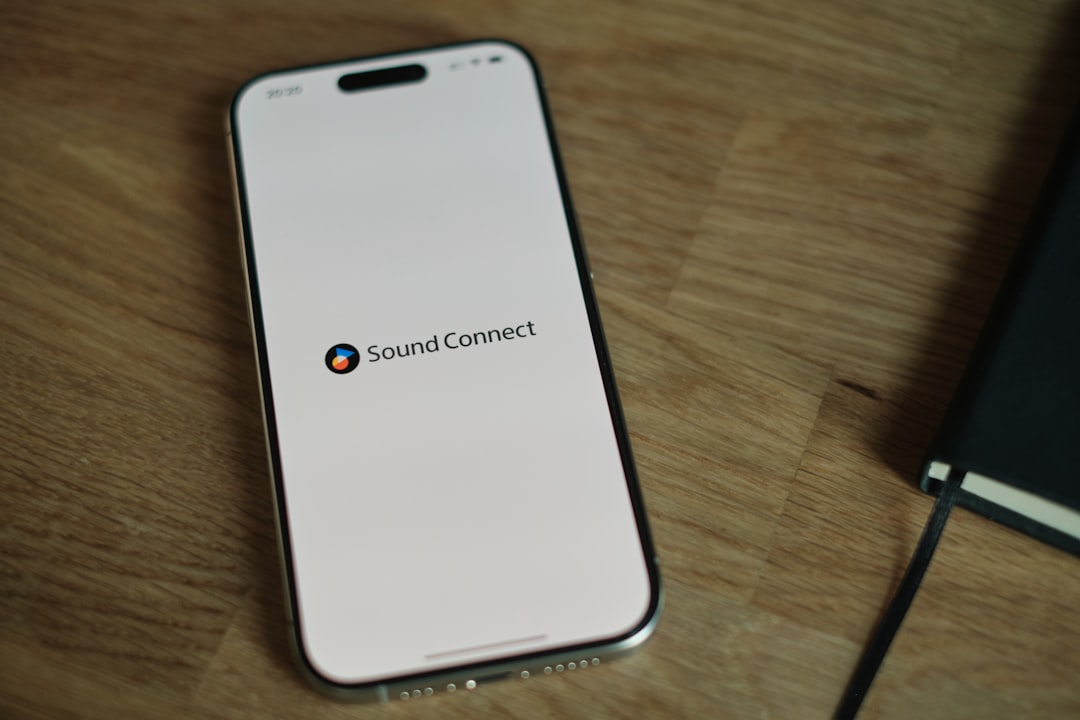 A cell phone sitting on top of a wooden table