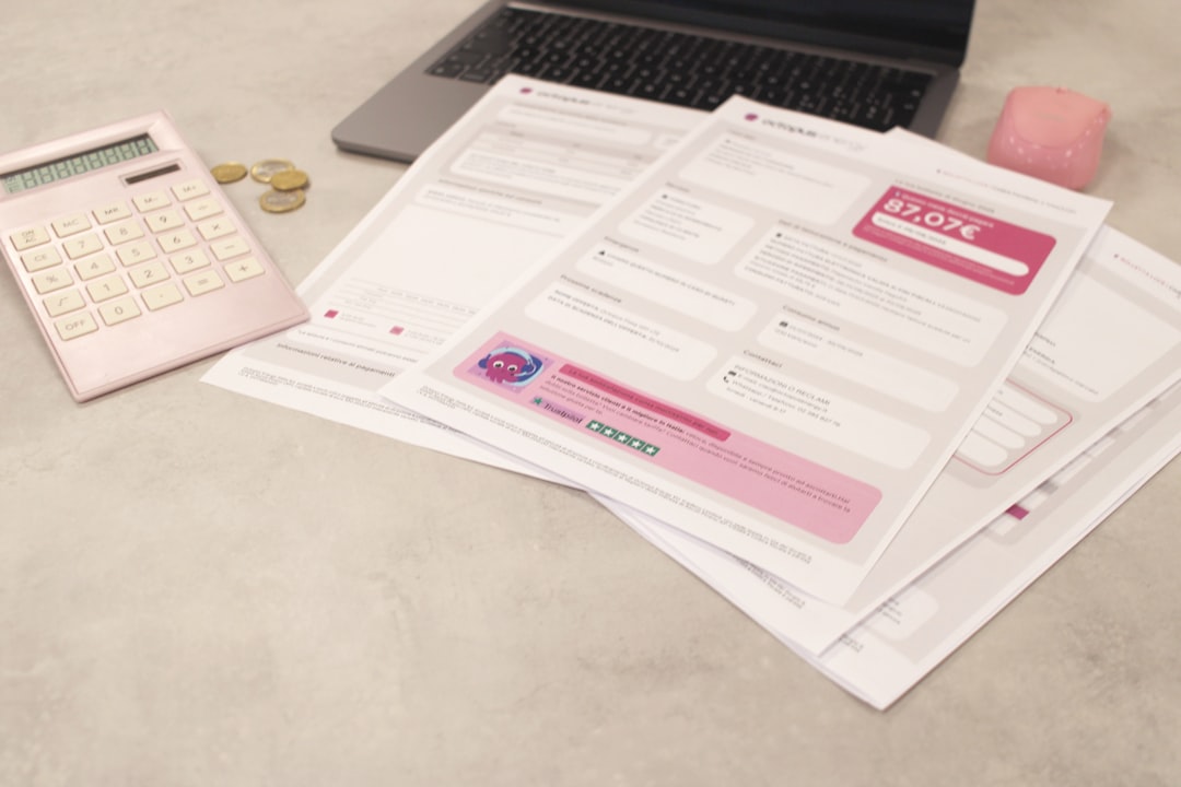 Bills and calculator sit on a desk.